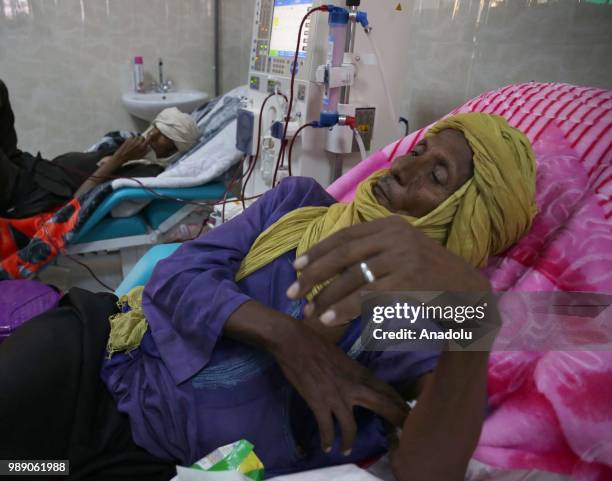 An African migrant patient, who will be repatriated to their countries, receives medical treatment at Tamanrasset Hospital of the refugee camp...