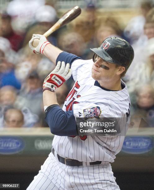 Justin Morneau of the Minnesota Twins follows through on a hit in a game against the Detroit Tigers at Target Field on May 5, 2010 in Minneapolis, MN.