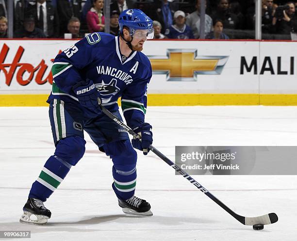 Henrik Sedin of the Vancouver Canucks skates up ice with the puck in Game Three of the Western Conference Semifinals against the Chicago Blackhawks...