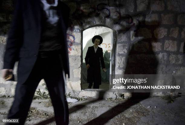 Ultra-Orthodox Jewish men leave after praying at the tomb of Jewish biblical figure Calev ben Yefuneh in the northern Palestinian village of Kifl...