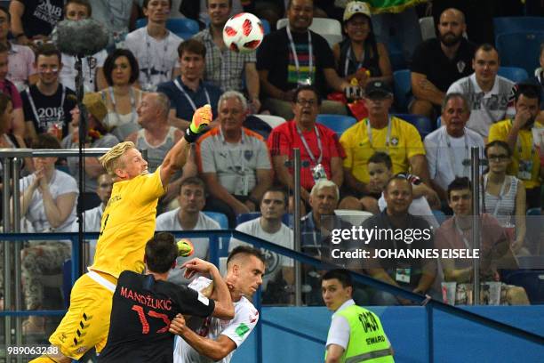 Denmark's goalkeeper Kasper Schmeichel jumps to deflect the ball during the Russia 2018 World Cup round of 16 football match between Croatia and...