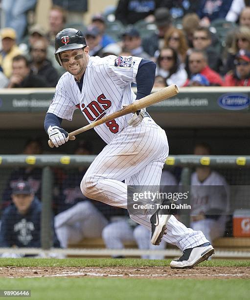 Nick Punto of the Minnesota Twins bunts during a game against the Detroit Tigers at Target Field on May 5, 2010 in Minneapolis, MN.