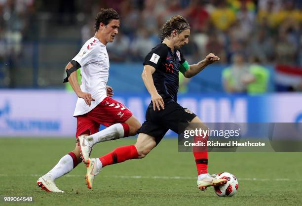 Luka Modric of Croatia is challenged by Thomas Delaney of Denmark during the 2018 FIFA World Cup Russia Round of 16 match between Croatia and Denmark...