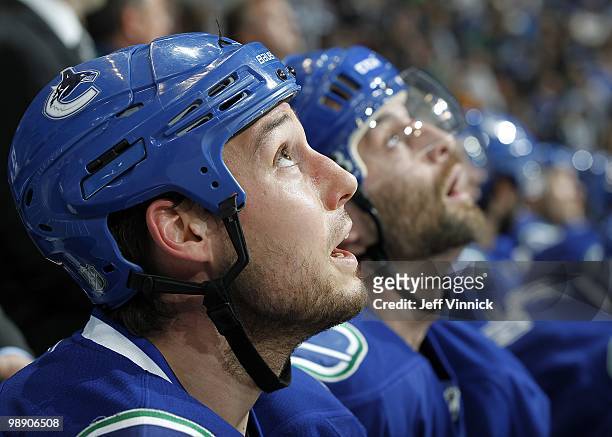 Kyle Wellwood of the Vancouver Canucks and Pavol Demitra looks on from the bench in Game Three of the Western Conference Semifinals against the...