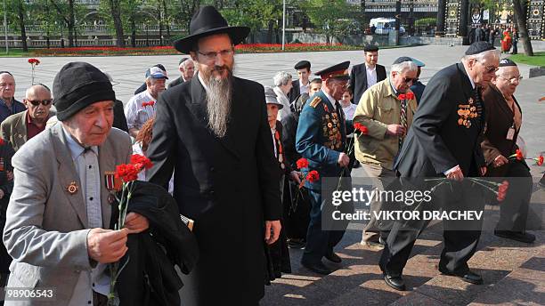 Russia's chief Rabbi Berl Lazar and members of Moscow's Jewish community lay flowers at the Tomb of the Unknown Soldier in central Moscow on May 7,...