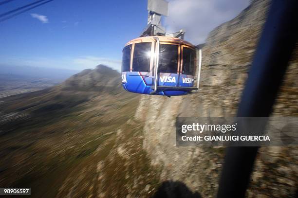 Cable car, seen through the window of an ascending cable car, on the Table mountain cableway on May 7, 2010 in Cape Town. Table Mountain cableway has...