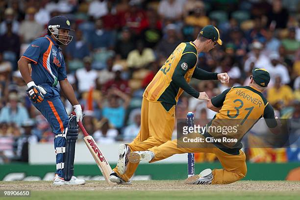 Michael Clarke of Australia catches Suresh Raina of India and collides with David Warner during the ICC World Twenty20 Super Eight match between...
