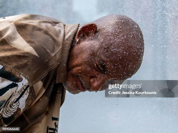 Eduardo Velev cools off in the spray of a fire hydrant during a heatwave on July 1, 2018 in Philadelphia, Pennsylvania. An excessive heat warning has...