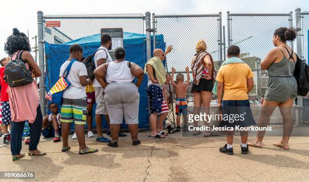 People wait in line at a public pool that is filled to capacity during a heatwave on July 1, 2018 in Philadelphia, Pennsylvania. An excessive heat...