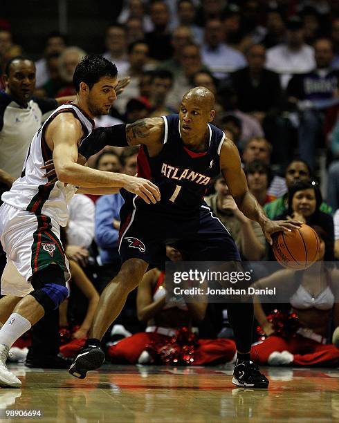 Maurice Evans of the Atlanta Hawks moves against Carlos Delfino of the Milwaukee Bucks in Game Four of the Eastern Conference Quarterfinals during...