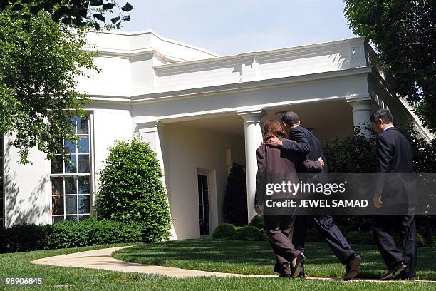 President Barack Obama holds Labor Secretary Hilda Solis as Commerce Secretary Gray Locke follows after Obama spoke on monthly jobs numbers on the...