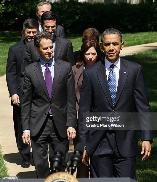 President Barack Obama walks out to speak with by Treasury Secretary Timothy Geithner, Secretary of Labor Hilda Solis, Director of the Office of...