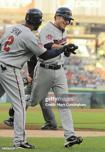 Luke Hughes of the Minnesota Twins is congratulated by teammate Denard Span after hitting a home run in his first major league at-bat during his...