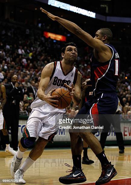 Carlos Delfino of the Milwaukee Bucks drives against Al Horford of the Atlanta Hawks in Game Four of the Eastern Conference Quarterfinals during the...