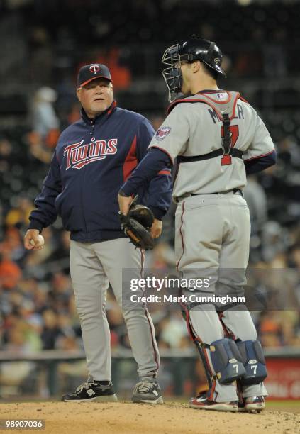 Manager Ron Gardenhire of the Minnesota Twins talks on the mound with catcher Joe Mauer during the game against the Detroit Tigers at Comerica Park...