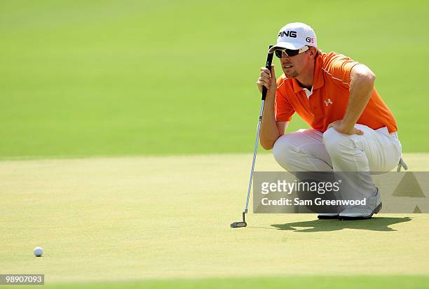 Hunter Mahan lines up his putt on the 18th hole during the second round of THE PLAYERS Championship held at THE PLAYERS Stadium course at TPC...