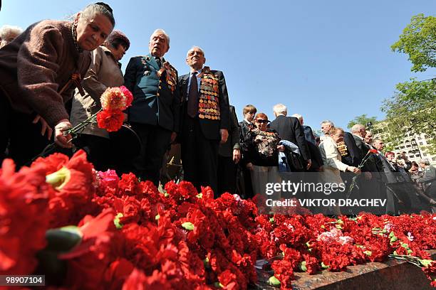 Russian WWII veterans lay flowers at the Tomb of the Unknown Soldier in central Moscow on May 7, 2010. Russian President Dmitry Medvedev slammed the...