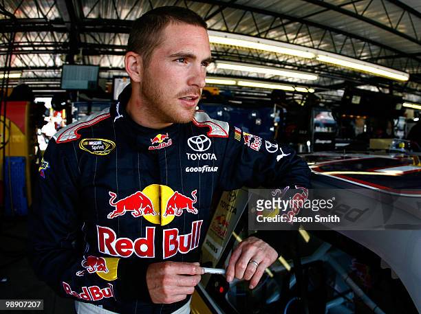 Scott Speed, driver of the Red Bull Tooyta, looks on in the garage during practice for the NASCAR Sprint Cup Series Showtime Southern 500 at...