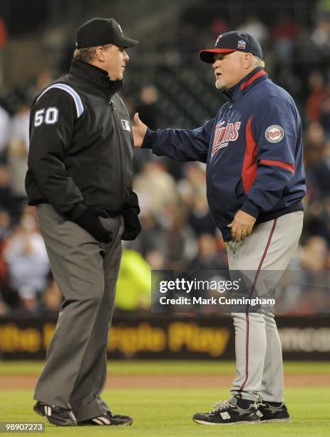 Manager Ron Gardenhire of the Minnesota Twins argues a call with Major League umpire Paul Emmel during the game against the Detroit Tigers at...