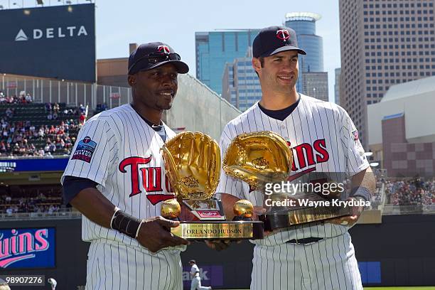 Orlando Hudson and Joe Mauer of the Minnesota Twins pose with their 2009 Golden Glove awards before the game with the Kansas City Royals on April 18,...