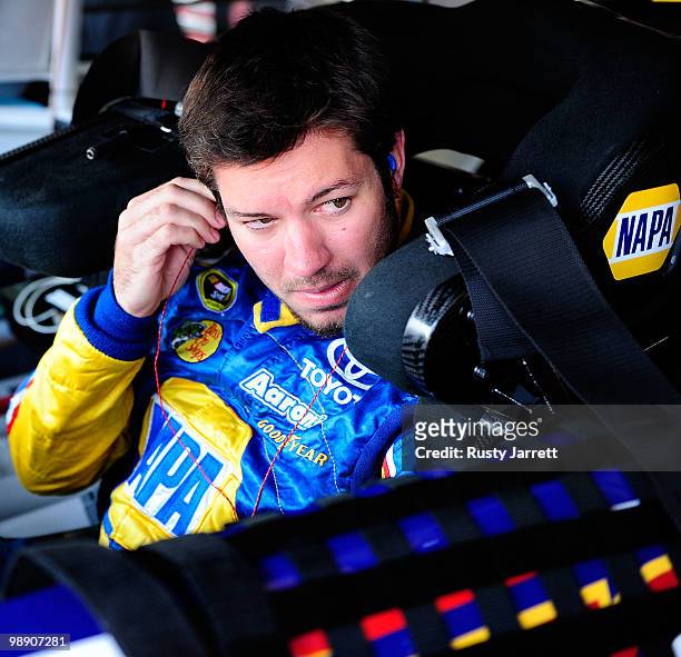 Martin Truex Jr., driver of NAPA Auto Parts Toyota, adjusts his ear piece, dduring practice for the NASCAR Sprint Cup Series Showtime Southern 500 at...