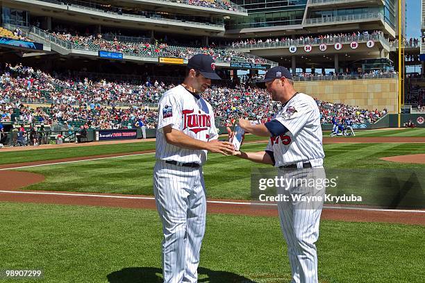 Joe Mauer of the Minnesota Twins is presented with the Players Choice Award as the 2009 American League Outstanding Player by Michael Cuddyer before...