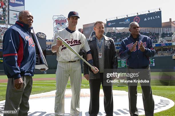 Joe Mauer of the Minnesota Twins poses with the 2009 American League batting championship award before the game with the Kansas City Royals on April...