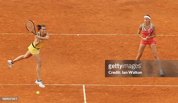 Flavia Pennetta of Italy with her team mate Gisela Dulko of Argentina in action in the doubles against Nadia Petrova of Russia and Liezel Huber of...
