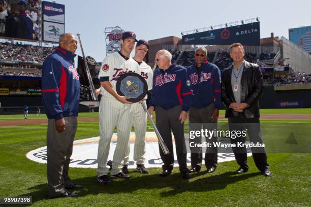 Joe Mauer of the Minnesota Twins poses with the 2009 MVP award before the game with the Kansas City Royals on April 17, 2010 at Target Field in...