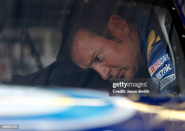 Kurt Busch, driver of the Miller Lite Dodge, looks inside his car in the garage during practice for the NASCAR Sprint Cup Series Showtime Southern...