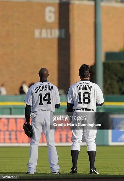 Austin Jackson and Johnny Damon of the Detroit Tigers stand together during the National Anthem before the game against the Minnesota Twins at...