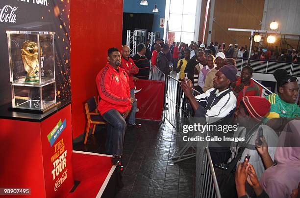 South African football fans queue to see the FIFA World Cup trophy at the O.R Tambo center after the unveiling, during the kick off of its South...