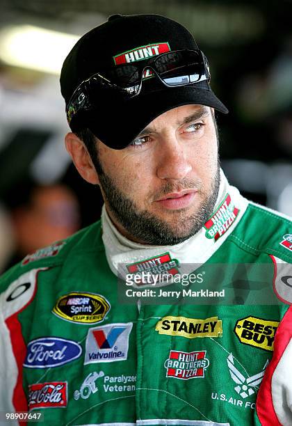 Elliott Sadler, driver of the Hunt Brothers Pizza Ford waits in the garage during practice for the NASCAR Sprint Cup Series Showtime Southern 500 at...