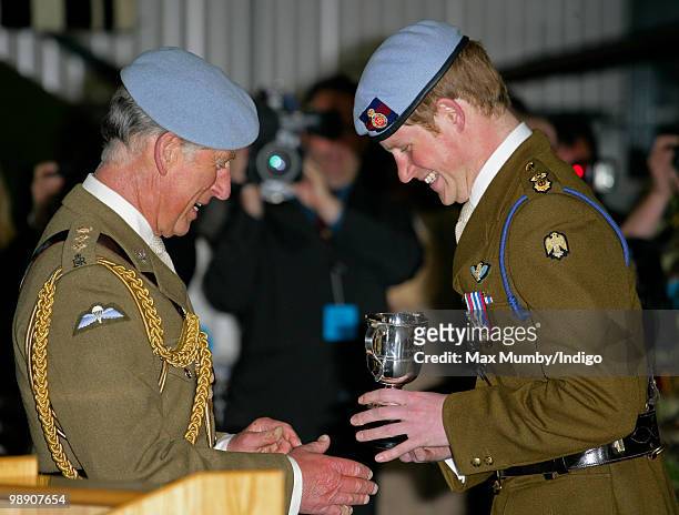 Prince Charles, The Prince of Wales, Colonel in Chief of the Army Air Corps presents HRH Prince Harry with the Peter Adams Trophy for tactical...