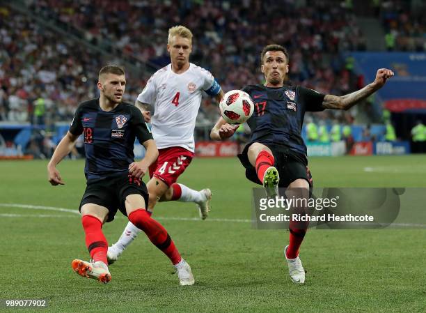 Ante Rebic and Mario Mandzukic of Croatia battle for the ball with Simon Kjaer of Denmark during the 2018 FIFA World Cup Russia Round of 16 match...