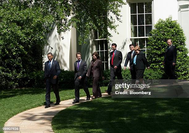 President Barack Obama, from left, walks out of the White House with Timothy Geithner, U.S. Treasury secretary, Hilda Solis, U.S. Secretary of labor,...