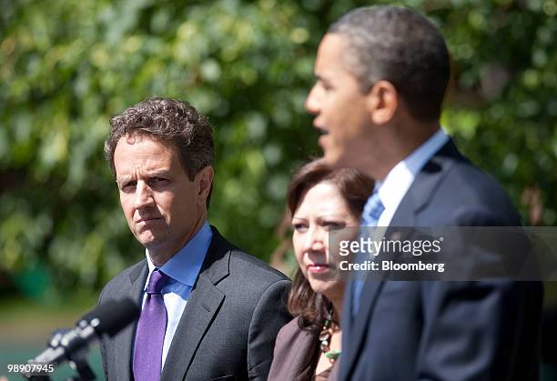 Timothy Geithner, U.S. Treasury secretary, left, and Hilda Solis, U.S. Secretary of labor, listen to U.S. President Barack Obama makes a statement on...