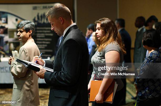 Job applicants line up for interviews at a career fair hosted by National Career Fairs May 7, 2010 in McLean, Virginia. The U.S. Economy added...