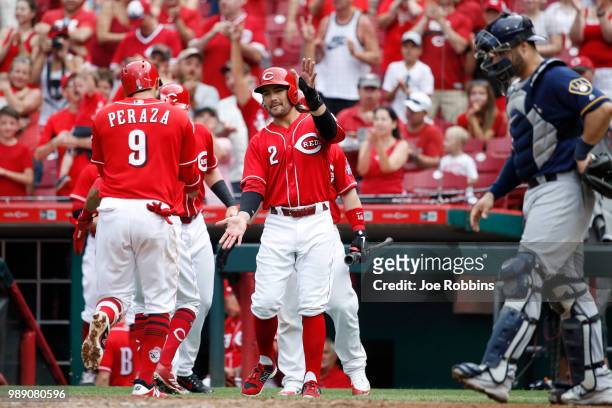 Jose Peraza of the Cincinnati Reds celebrates with Alex Blandino after hitting a grand slam home run in the sixth inning against the Milwaukee...