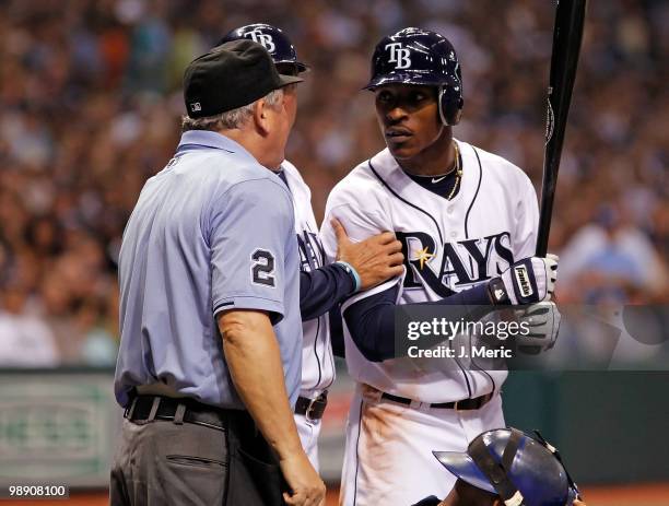 Outfielder B.J. Upton of the Tampa Bay Rays argues with homeplate umpire Jerry Crawford as third base coach Tom Foley tries to intervene during the...