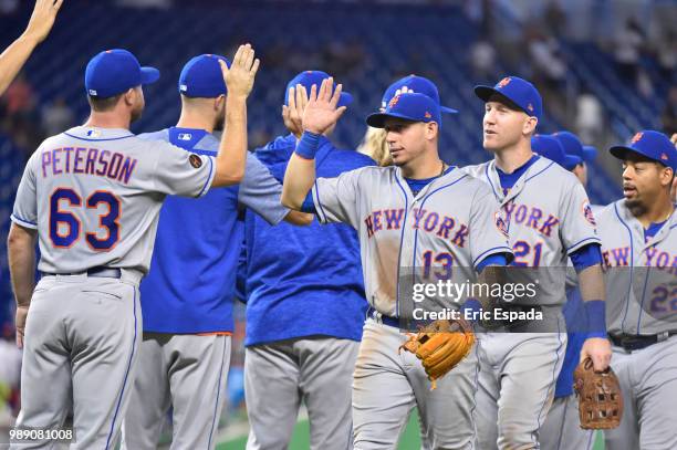 Asdrubal Cabrera of the New York Mets high fives Tim Peterson after defeating the Miami Marlins at Marlins Park on July 1, 2018 in Miami, Florida.