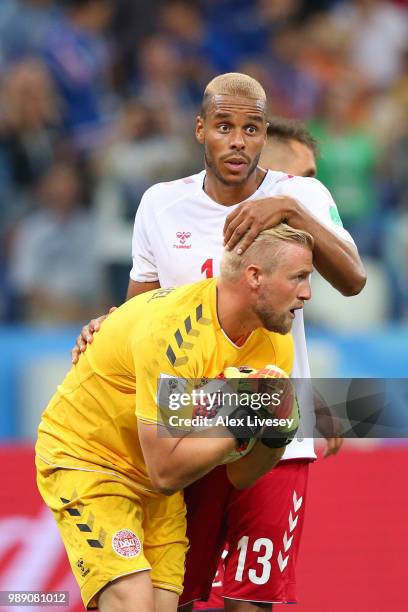 Kasper Schmeichel of Denmark celebrates saving a penalty, from Luka Modric of Croatia with team mate Mathias Jorgensen during the 2018 FIFA World Cup...