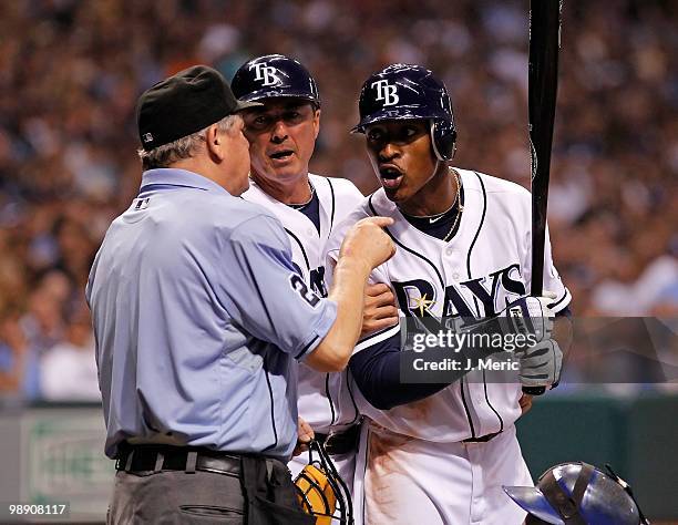Outfielder B.J. Upton of the Tampa Bay Rays argues with homeplate umpire Jerry Crawford as third base coach Tom Foley tries to intervene during the...