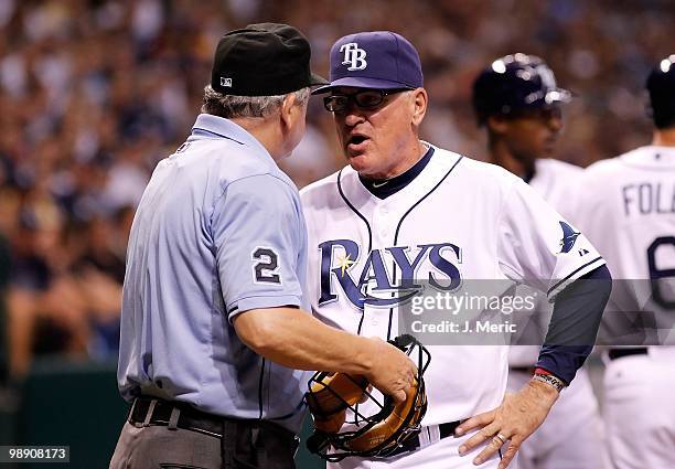 Manager Joe Maddon of the Tampa Bay Rays talks with homeplate umpire Jerry Crawford during the game against the Kansas City Royals at Tropicana Field...