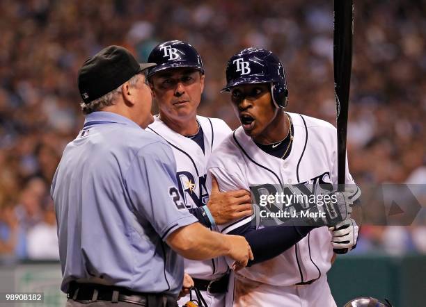 Outfielder B.J. Upton of the Tampa Bay Rays argues with homeplate umpire Jerry Crawford as third base coach Tom Foley tries to intervene during the...