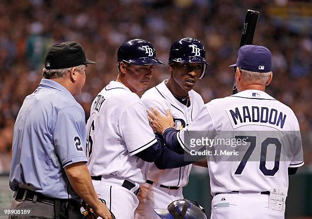 Outfielder B.J. Upton of the Tampa Bay Rays argues with homeplate umpire Jerry Crawford as third base coach Tom Foley and Manager Joe Maddon try to...