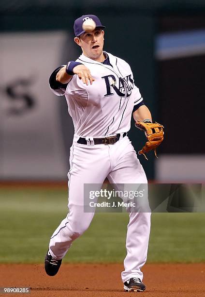 Infielder Evan Longoria of the Tampa Bay Rays throws over to first for an out against the Kansas City Royals during the game at Tropicana Field on...