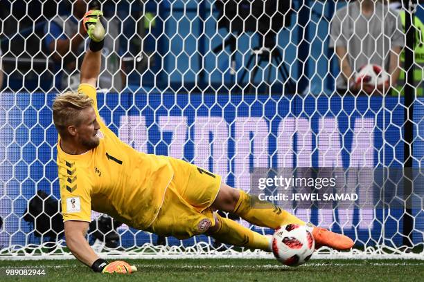 Denmark's goalkeeper Kasper Schmeichel dives to stop the ball during the penalty shootout during the Russia 2018 World Cup round of 16 football match...