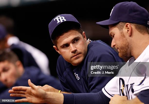 Catcher Kelly Shoppach of the Tampa Bay Rays talks with pitcher Wade Davis in the dugout during the game against the Kansas City Royals at Tropicana...