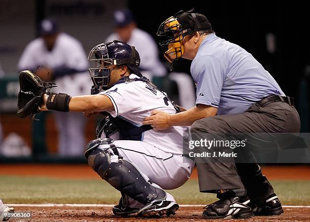 Catcher Dioner Navarro of the Tampa Bay Rays catches while homeplate umpire Jerry Crawford looks on against the Kansas City Royals during the game at...